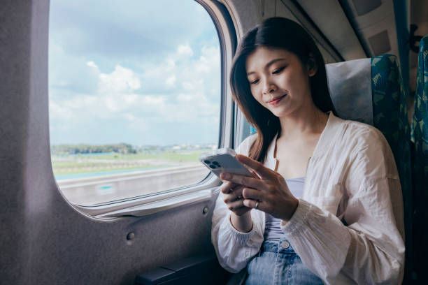 istock A female backpacker uses her smartphone to check information while sitting on the train. she focuses on the screen, planning her next destination as the train moves along. 2179943570