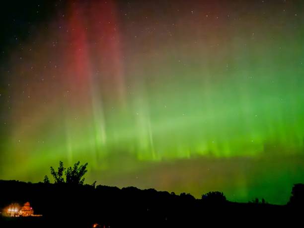 istock Aurora Borealis Over Silhouetted Landscape 2179945375
