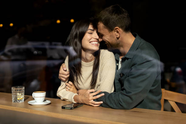 istock Young loving couple embracing in a cafe 2179947165