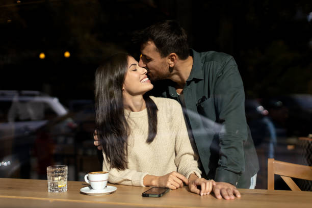 istock Young loving couple embracing in a cafe 2179947266