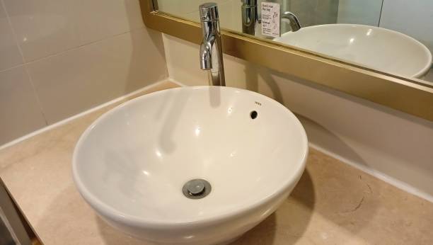 istock white sink with glass background in hotel room. 2179948417
