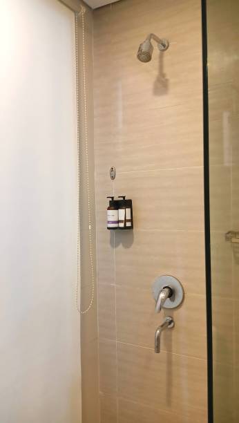 istock bath shower used, soap dish, shampoo and glass divider in a hotel. 2179948433
