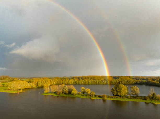 Rainbow during an autumn rain shower over the river IJssel near Zwolle in Overijssel, Netherlands.