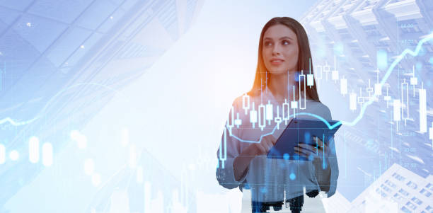 istock Businesswoman using tablet, graph chart with forex and candlesticks 2179954362