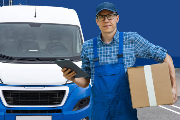 istock Delivery man in uniform is holding  digital tablet and box. 2179954517