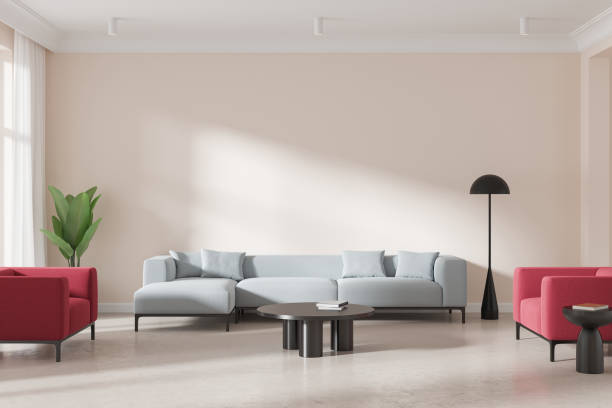 istock Modern living room featuring light blue sectional sofa and red armchairs. Minimalist decor with floor lamp, coffee table, and plant. Concept of home interior. 3D Rendering 2179954538