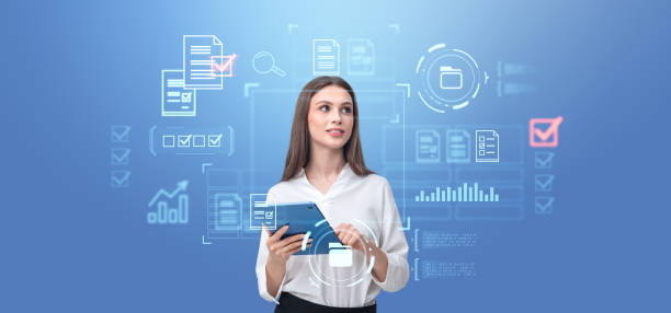istock Woman using tablet, glowing hologram with document management system and audit 2179956846