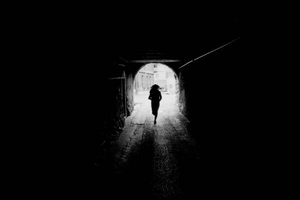 istock A girl running in a tunnel 2179959308