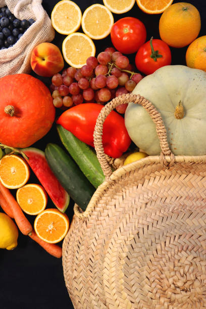 istock Straw Bag And Healthy Produce On Dark Background 2179959462