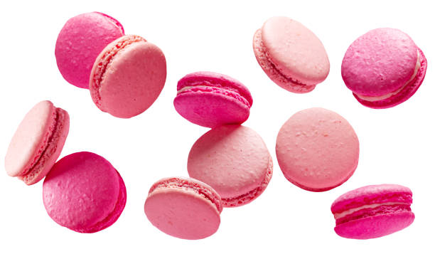 French strawberry macarons levitating in air on white background. File Contains clipping paths.