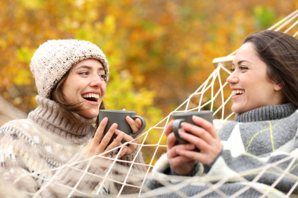 istock Happy women drinking and talking in autumn forest 2179965704