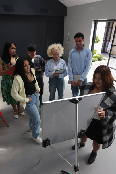 istock People standing and looking at whiteboard during meeting 2179966613