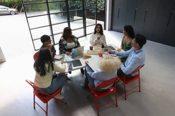 istock People sitting around table during business meeting 2179966903