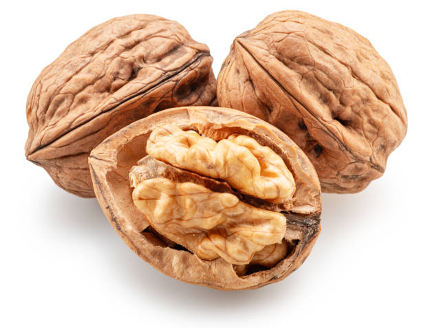 istock Whole walnuts, broken walnut with kernel and green leaves isolated on white background. Clipping path. 2179968165