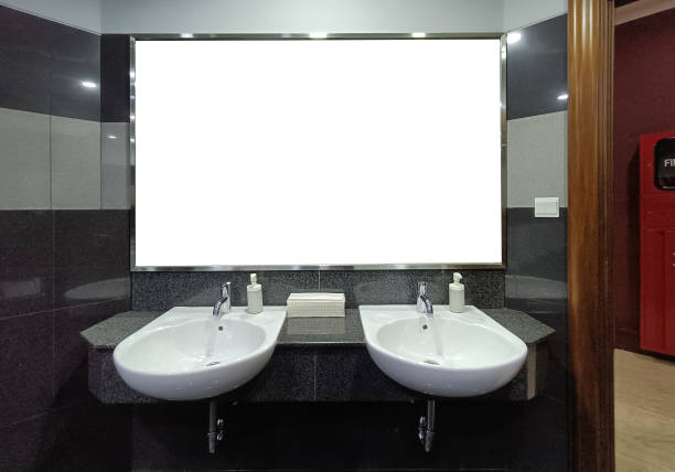 A modern bathroom featuring twin white vessel sinks atop an orange vanity, complemented by two mirrors and a white shower curtain for a fresh, clean aesthetic.