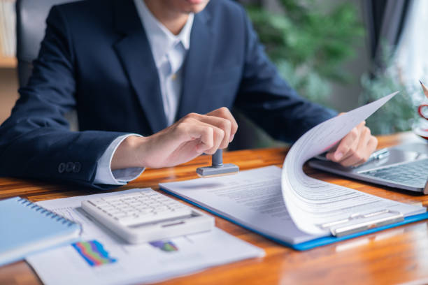 istock Man carefully reviewed finance agreements and contract documents with his client, discussing loan, mortgage, investment opportunities, credit terms, and tax implications for their business. 2179969821