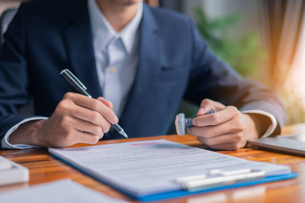 istock Man carefully reviewed finance agreements and contract documents with his client, discussing loan, mortgage, investment opportunities, credit terms, and tax implications for their business. 2179969887