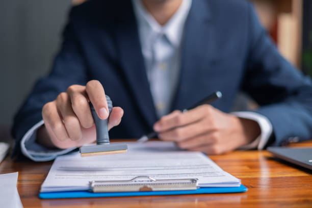 istock Man carefully reviewed finance agreements and contract documents with his client, discussing loan, mortgage, investment opportunities, credit terms, and tax implications for their business. 2179969889