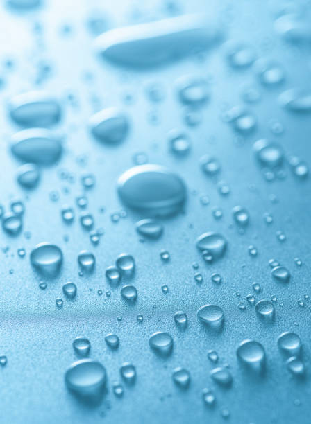 istock Water drops or condensation drops on surface, macro shot. Water drops background as a symbol of freshness and purity. Vertical shot. 2179970501