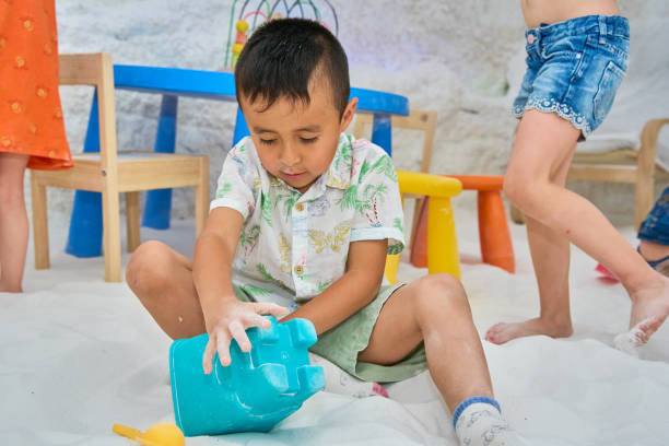 istock Boy playing with toys in a salt cave during halotherapy session 2179970752