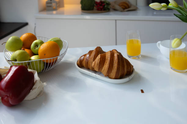 istock Breakfast croisant and fruits on white table morning food 2179972010