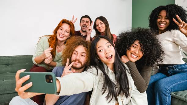 istock Excited diverse friends gesturing while taking self-portraits at home 2179974134
