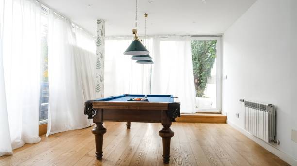 istock Pendant lights over billiard table in game room at home 2179974424