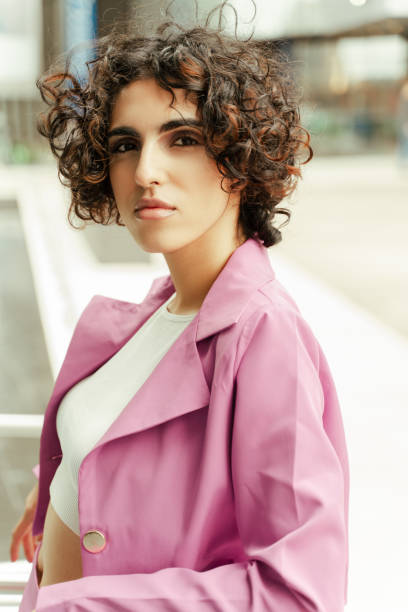 istock Young stylish woman posing wearing a pink suit jacket 2179976806