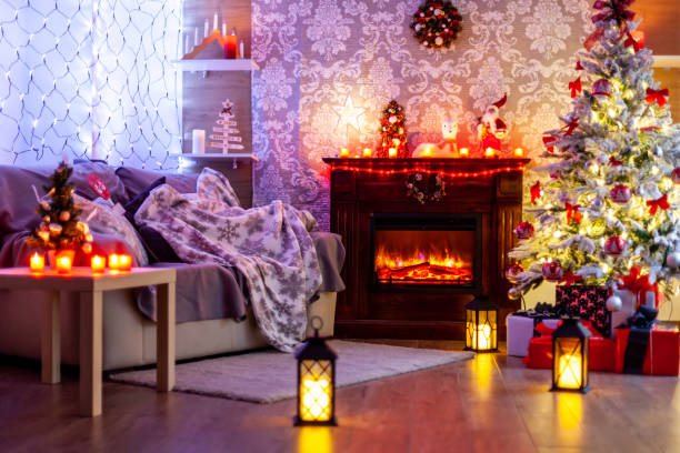 istock Decorated Christmas tree in front of the fireplace with various candles. 2179979052