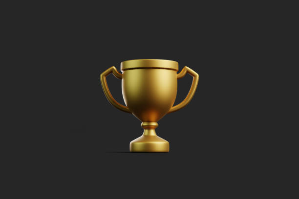 istock Front view of golden trophy cup on dark background 2179980550