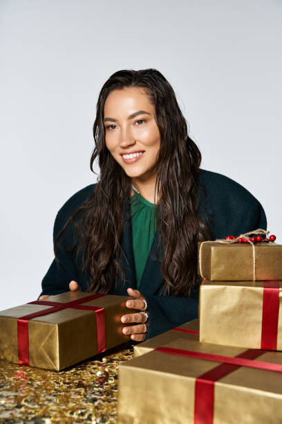 istock This joyful woman radiates Christmas cheer while surrounded by elegantly wrapped gifts 2179982128
