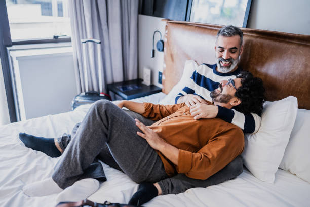 istock Gay couple embracing and talking in a hotel 2179987270