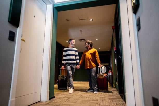 istock Gay couple talking and walking in a hotel 2179987341