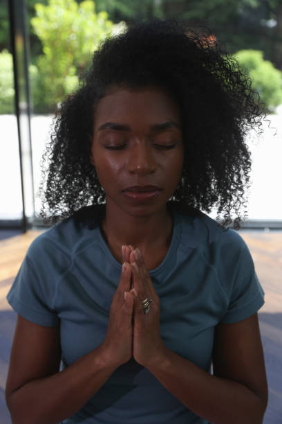 istock Woman meditating with clasped hands 2179987357