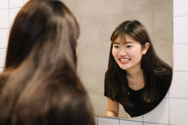 istock Young asian woman brushing teeth 2179995632
