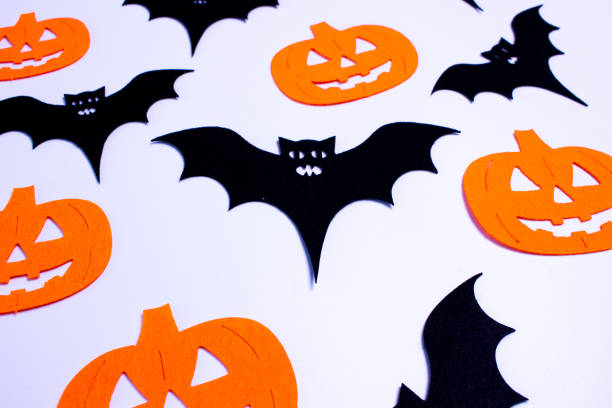 istock Black bats and orange pumpkins on white background 2179997194