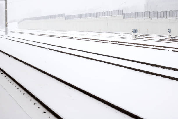 Train rails in the snow in a snowstorm close up