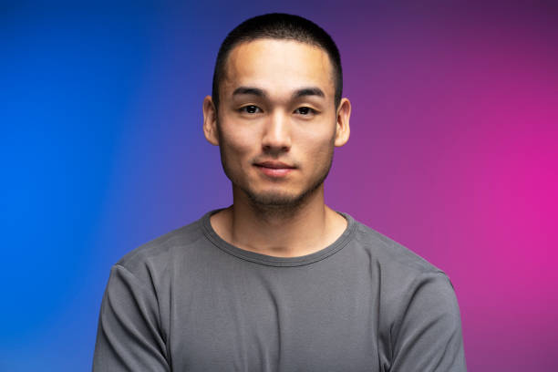 istock Young adult man posing with neutral expression on colorful background 2180000548
