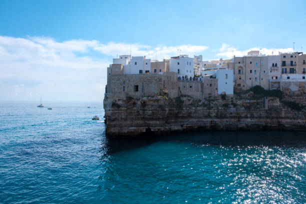 istock Stunning coastal cliffs of Puglia, Italy, with sunlit whitewashed buildings 2180000842