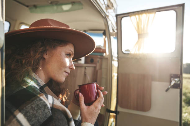 istock Woman Enjoying a Hot Drink Inside Camper Van 2180002900