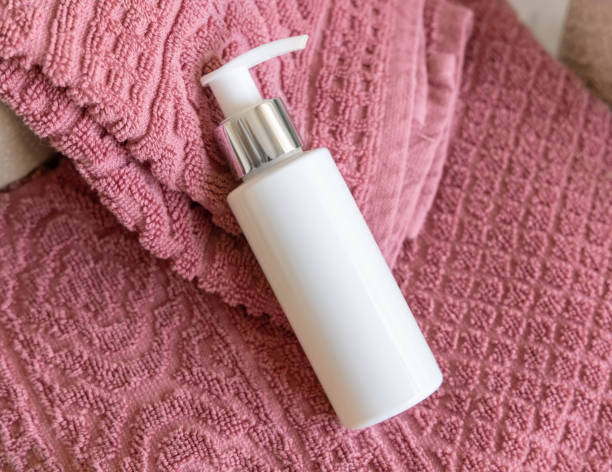 istock White blank pump bottle on pink folded bath towels close up, cosmetic mockup 2180003285