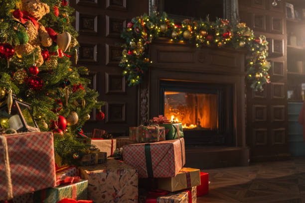istock Classical Christmas decorated interior living room library with fireplace. Christmas tree with red golden ornament decorations. Modern classic style interior design apartment. Christmas eve at home. 2180003427