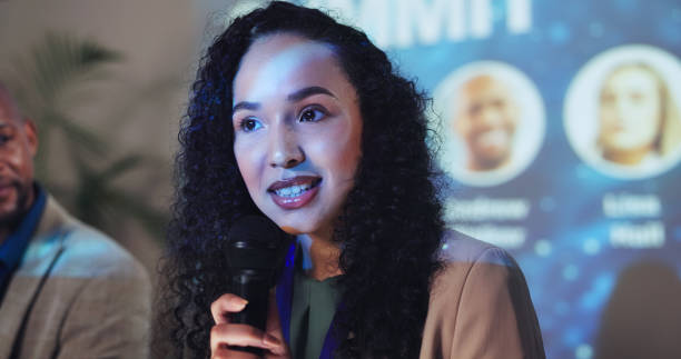 istock Conference, speech and keynote speaker with business woman and technology for networking, industry panel and summit. Convention, stage and ai ethics with seminar for audience, event showcase or news 2180004885