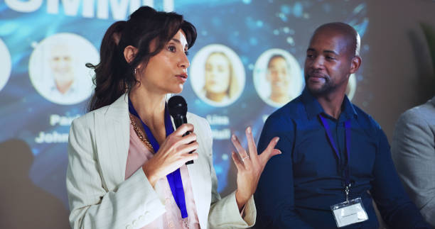 istock Stage, seminar and microphone with business people and technology for networking, industry panel and keynote speaker. Hackathon, summit and ai ethics with speech for audience, event showcase and news 2180004926