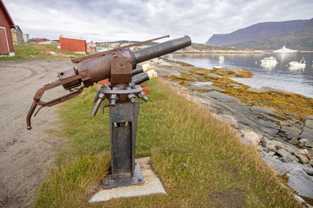 Old cannon from a whale hunting ship placed on the harbor in Qeqertarsuaq also known as Godhavn in Greenland