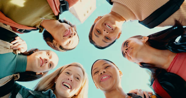 istock Students, happy and education with friends from low angle for learning, college and studying knowledge. University, support and community with group of people for teamwork, diversity and huddle 2180005243