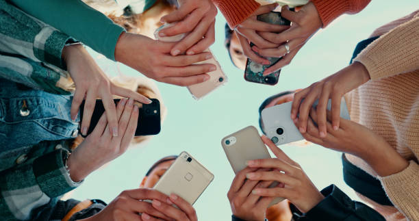 istock Outdoor, people hands with smartphone for connection, networking and share information for location. Group, friends and solidarity with cellphone for mobile app, download or social media by low angle 2180005250