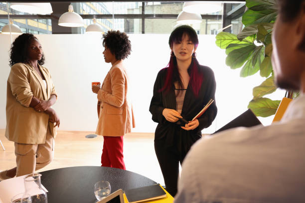 istock Diverse group of business people standing in office 2180007410