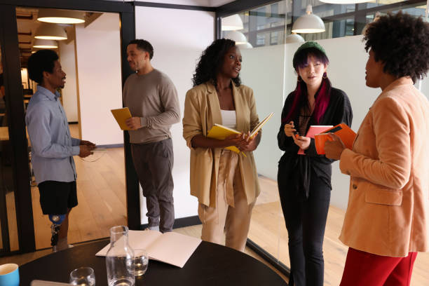 istock Diverse group of business people standing in office 2180007495
