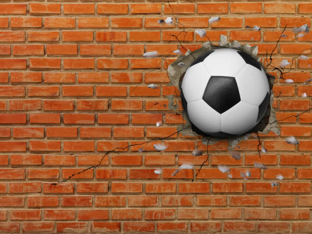 istock Soccer Ball Breaks Through Wall, Strong Sports Concept. 2180007496